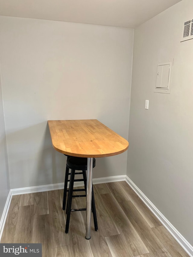 unfurnished dining area featuring wood-type flooring