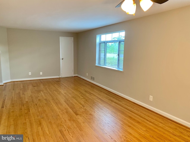 unfurnished room with ceiling fan and light wood-type flooring