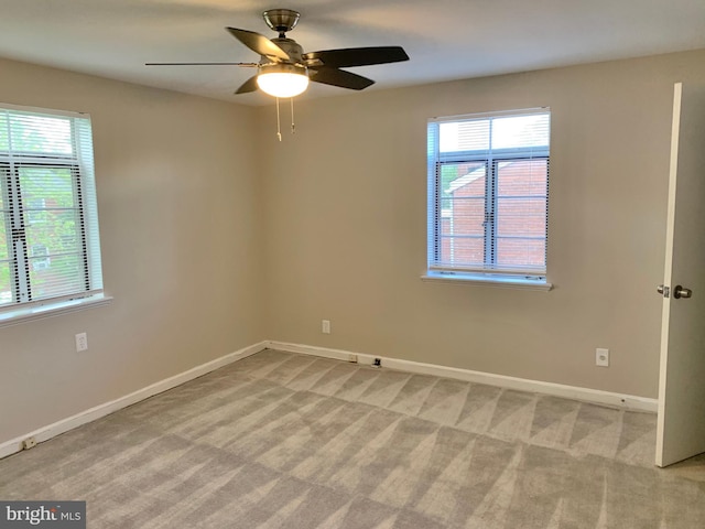 unfurnished room featuring ceiling fan and light carpet