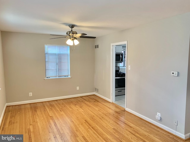 spare room with ceiling fan and light hardwood / wood-style flooring