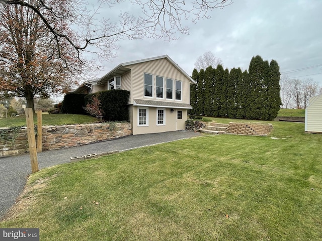 back of house featuring a lawn