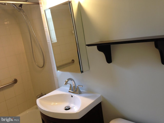 full bathroom with vanity, toilet, and tiled shower / bath