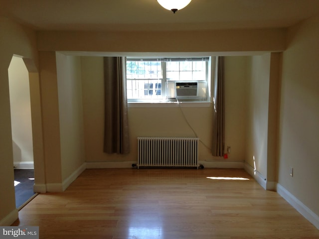 spare room with radiator and light hardwood / wood-style flooring