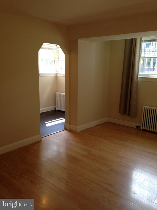 bonus room featuring radiator and wood-type flooring