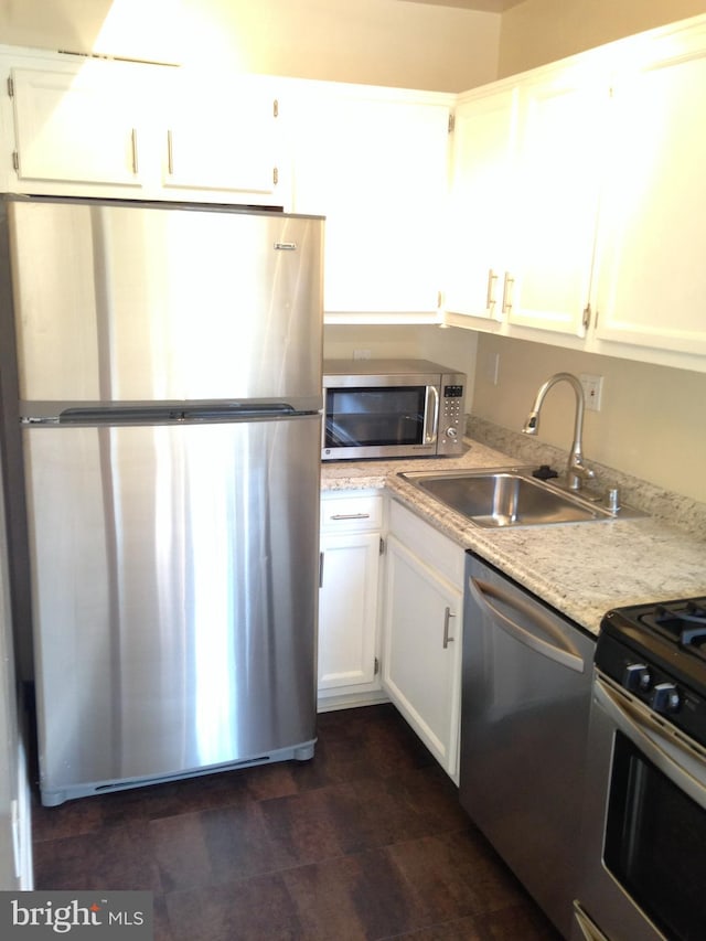 kitchen with white cabinetry, sink, and stainless steel appliances