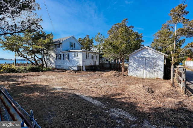 view of side of home with a shed