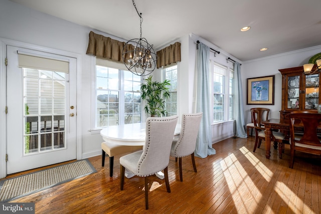 dining space featuring ornamental molding, dark hardwood / wood-style floors, and a notable chandelier