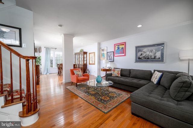 living room featuring crown molding and light wood-type flooring