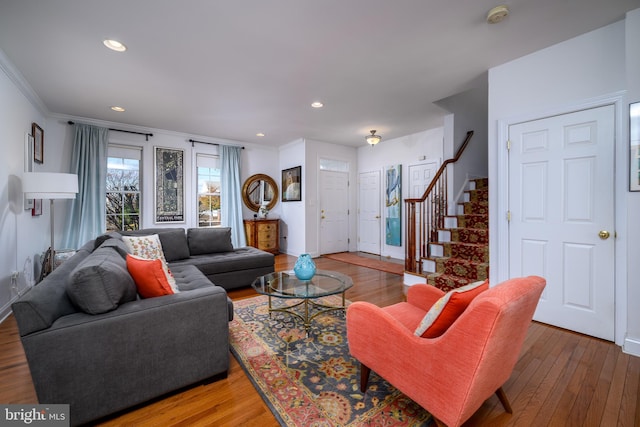 living room featuring hardwood / wood-style flooring and crown molding