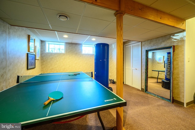 recreation room with a paneled ceiling and carpet floors