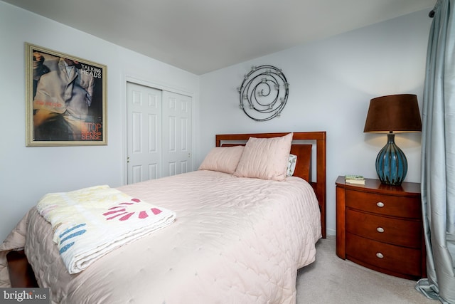 bedroom featuring light colored carpet and a closet