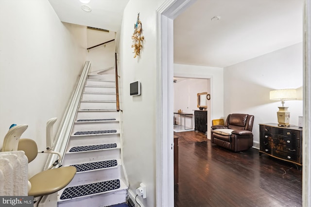 staircase with hardwood / wood-style floors