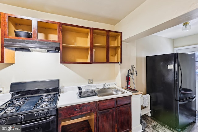 kitchen with dark hardwood / wood-style flooring, sink, and black appliances