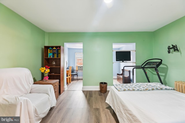 bedroom with hardwood / wood-style flooring and radiator