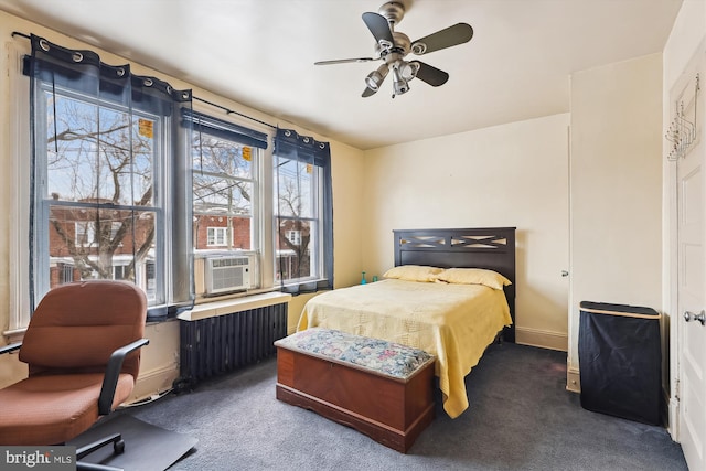 bedroom featuring cooling unit, radiator heating unit, ceiling fan, and dark colored carpet