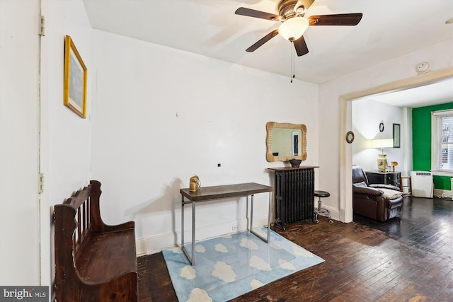 sitting room with ceiling fan and dark hardwood / wood-style floors