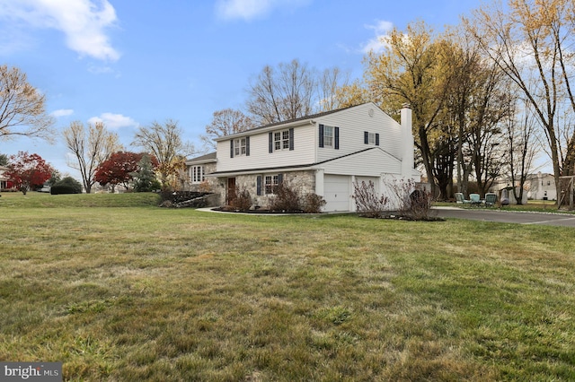 view of front of house featuring a garage and a front lawn