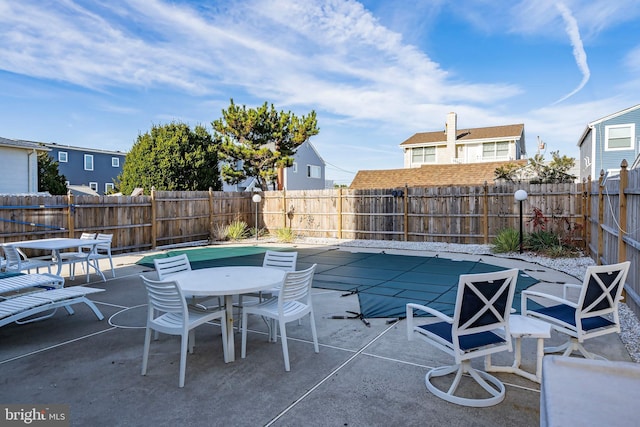 view of patio with outdoor dining space and a fenced backyard