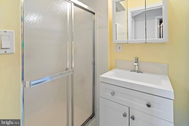 full bathroom featuring a shower stall and vanity