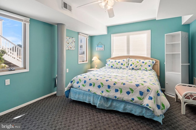 bedroom with carpet flooring, visible vents, baseboards, and ceiling fan