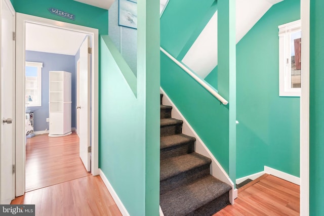 stairs featuring baseboards and wood finished floors