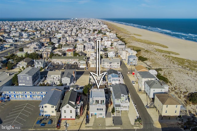 drone / aerial view with a residential view, a beach view, and a water view