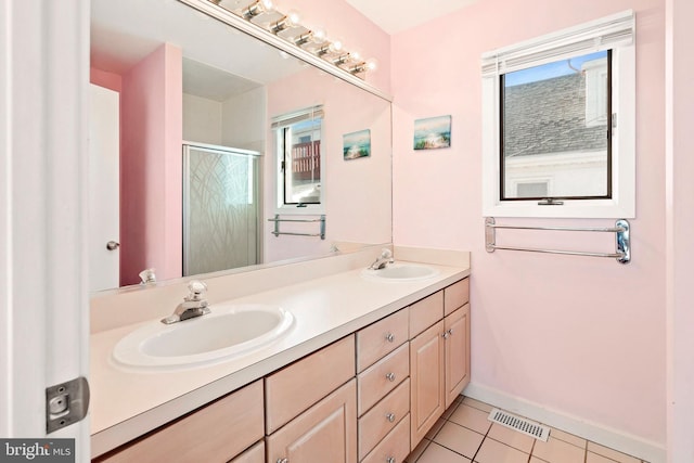 full bathroom with tile patterned floors, visible vents, a stall shower, and a sink