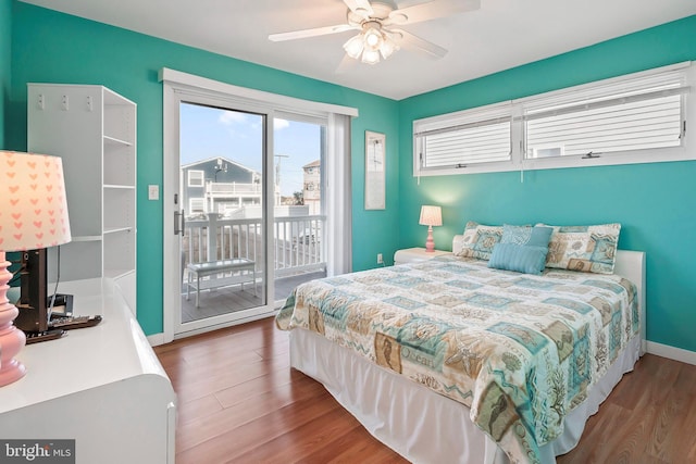 bedroom featuring access to exterior, wood finished floors, baseboards, and ceiling fan