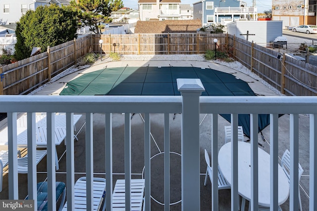 view of swimming pool featuring a residential view and a fenced backyard