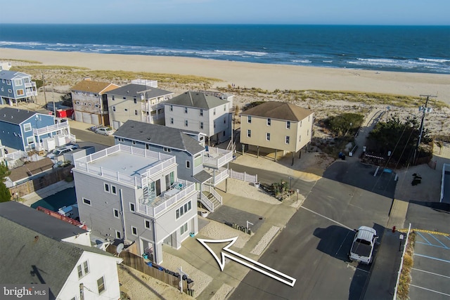 bird's eye view with a view of the beach, a water view, and a residential view