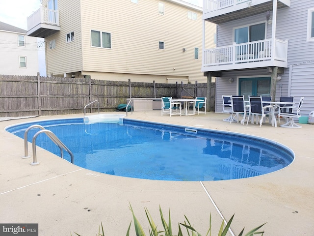 view of swimming pool featuring a patio, fence, and a fenced in pool