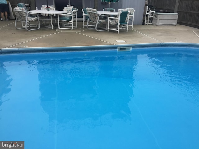 pool featuring outdoor dining area and a patio