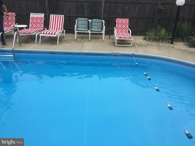 view of swimming pool with a fenced in pool and fence