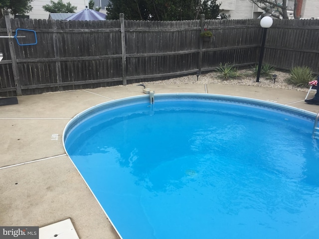 view of pool featuring fence