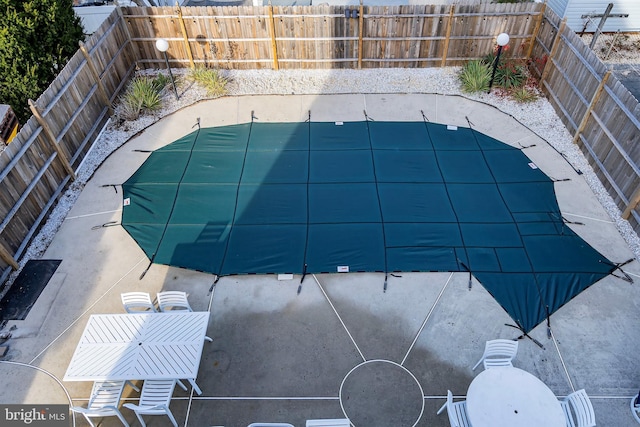 view of pool featuring a patio area and a fenced backyard