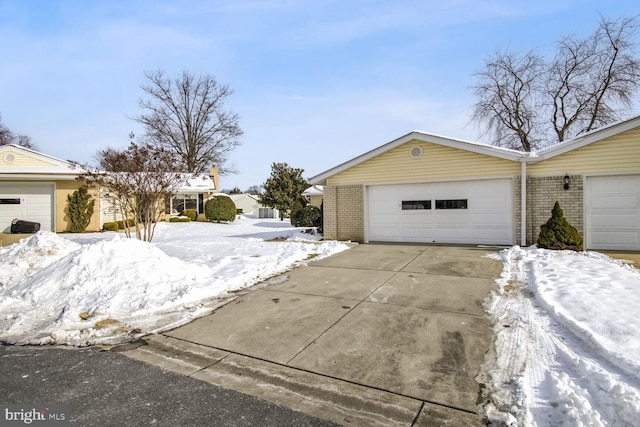 view of snow covered exterior with a garage