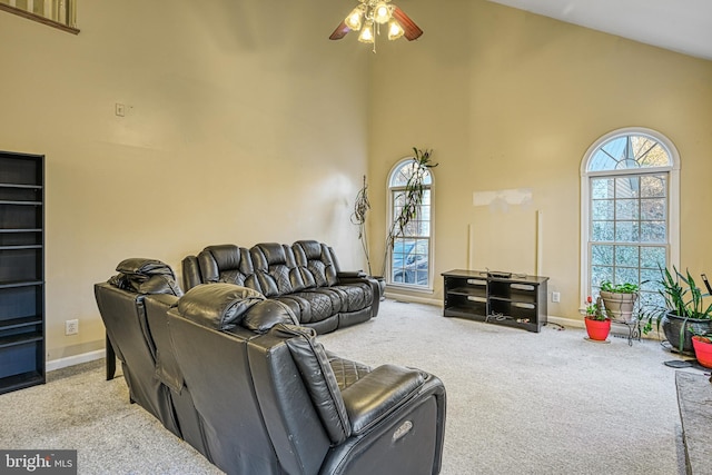 carpeted living room featuring high vaulted ceiling and ceiling fan