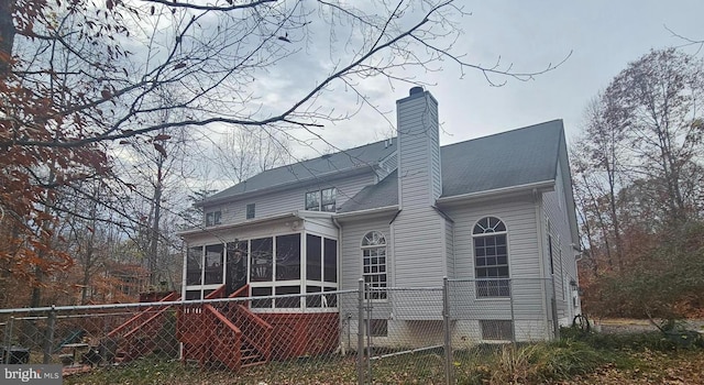 rear view of property with a sunroom