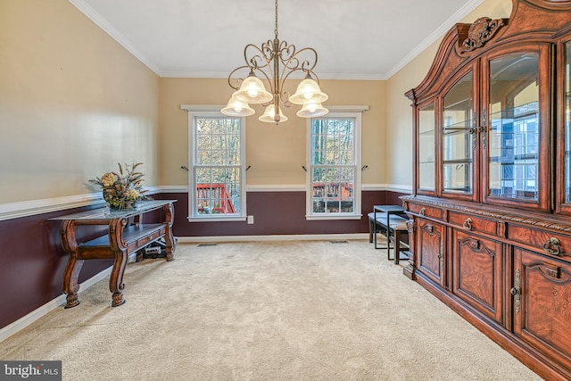 carpeted dining space featuring ornamental molding and an inviting chandelier