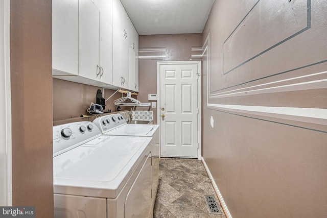 laundry area with cabinets and separate washer and dryer