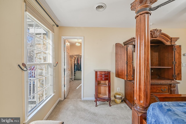 carpeted bedroom featuring a walk in closet and a closet