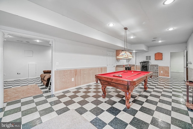 playroom with wooden walls and billiards