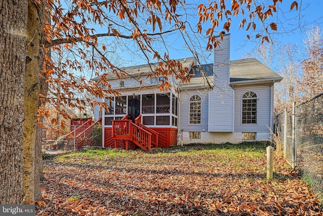 rear view of house with a sunroom