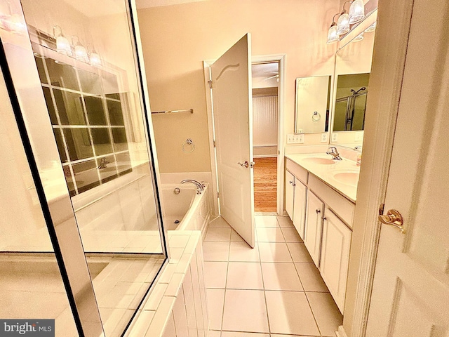 bathroom with tile patterned floors, separate shower and tub, and vanity