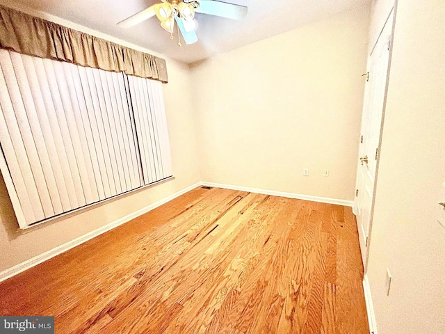 unfurnished room with ceiling fan and wood-type flooring