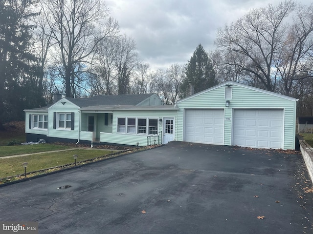 single story home with a garage and a front yard