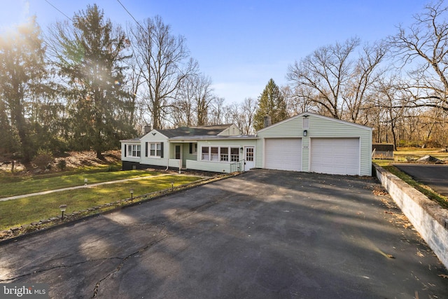 9732 Garis Shop Rd, Hagerstown, MD 21740 - view of front of house with asphalt driveway, a garage, a front yard, and a chimney