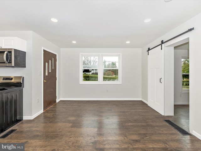 9732 Garis Shop Rd, Hagerstown, MD 21740 - unfurnished living room with a barn door, baseboards, recessed lighting, and dark wood-type flooring
