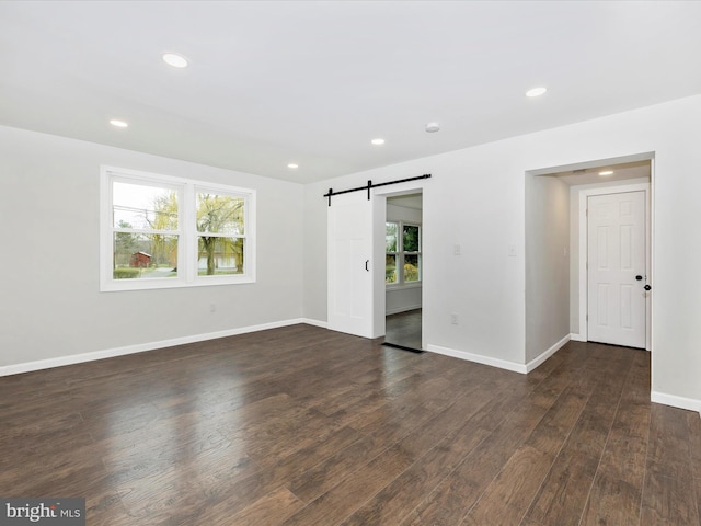 9732 Garis Shop Rd, Hagerstown, MD 21740 - empty room featuring a barn door, dark wood-type flooring, baseboards, and recessed lighting