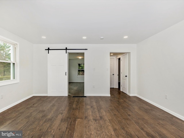 9732 Garis Shop Rd, Hagerstown, MD 21740 - unfurnished bedroom featuring a barn door, wood finished floors, baseboards, and recessed lighting